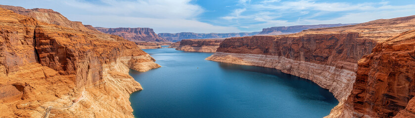 Breathtaking view of vast reservoir surrounded by stunning red rock formations, showcasing beauty of nature and serenity of water