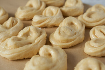 Raw buns on a baking sheet, close-up.