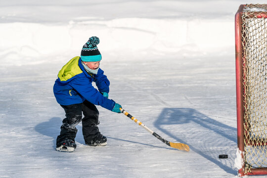 Happy child having fun playing winter sport outside