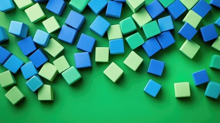 Blue and green cubes are artistically arranged against a vibrant green background, creating a colorful composition of blue and green cubes with ample copy space available.