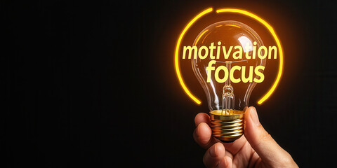 Hands holding glowing lightbulb symbolizing motivation and focus