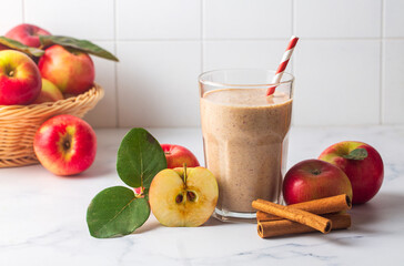 A delicious glass of apple smoothie or apple juice with fresh apple fruits