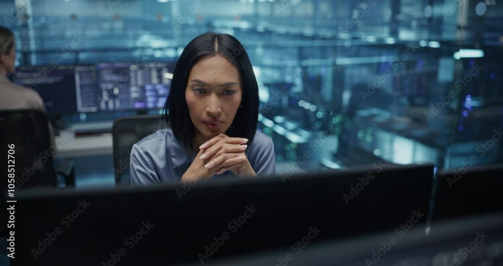 Poster beautiful asian female it engineer, surrounded by office equipment, studies her computer display in 
