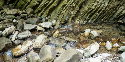 A rocky stream with a few rocks in it