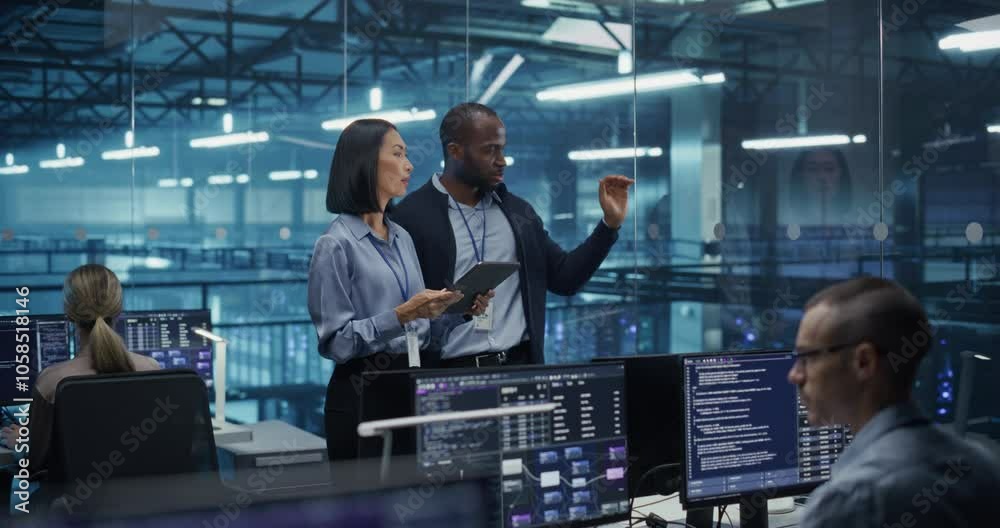 Poster Male DevOps Engineer and Female IT Consultant Using a Tablet Computer, Standing in an Office Above the Rows of Servers in a Data Center, Developing Automation Scripts for Artificial Intelligence