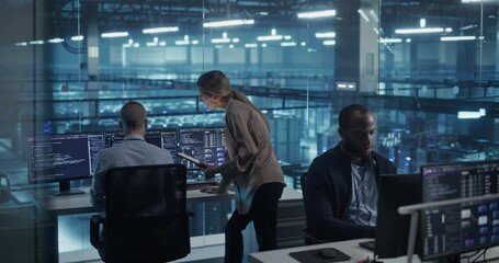Diverse Team of Developers Working on Computers in a Modern Office in a Data Center Facility. Team Analyzing Data and Optimizing Systems. Female Manager Having a Conversation with a Colleague - Powered by Adobe
