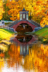 Cross bridge in autumn foliage in Alexander park, Tsarskoe Selo (Pushkin), Saint Petersburg, Russia