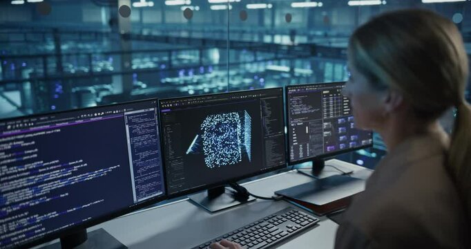 With Multiple Screens Open to Code and Analyze Neural Network Visualizations, Female Software Developer in a Data Center Refines an AI Algorithm, Working Methodically to Improve Performance