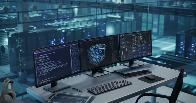 Workspace Without People Features Three Monitors Showcasing Artificial Intelligence Algorithms and Machine Learning Models, Set Up on a Sleek Desk in the Data Center&rsquo;s Glass-Walled Office