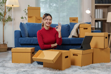 A charming SME owner Female entrepreneur working on receipt box Online order verification Online SME home business idea. Product counting according to order list.