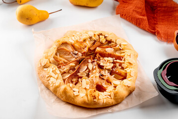 Freshly baked galette with pear on baking paper