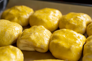 Raw buns on a baking sheet. Baking bread. Food concept