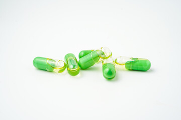 transparent pills with a mixture of green powder and oil, Food supplements, vitamins and minerals
