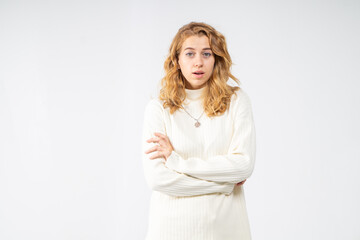 Surprised blonde girl on white background, waist-up portrait, copy space
