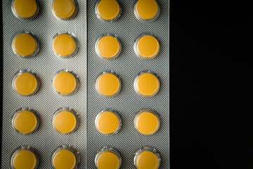 Brown Yellow Tablet pills blister Medicine on a black background