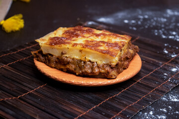 Beef lasagna served in plate isolated on dark background side view of bangladeshi fast food