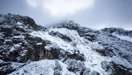 Snowy stone mountain. Snow covered rocky mountain