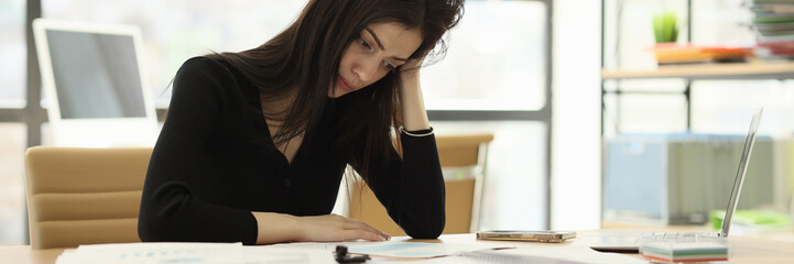 Upset office worker looks at wrong done report at desk