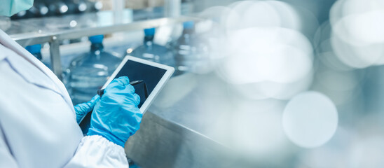 Closeup hygiene worker work with tablet software management technology for manage production in...