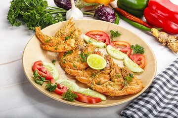 Grilled prawn served lime and vegetables
