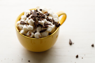 Cocoa and marshmallows in yellow ceramic cup