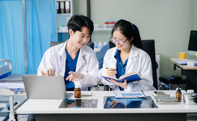 Doctors in lab coats discuss medication in a clinical setting, showcasing teamwork and collaboration