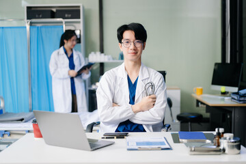 Doctor analyzing patient data on tablet in clinical lab. Medical professional in hospital with laptop, blood samples