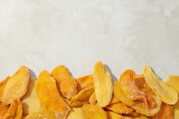 Dried mango chips on a white background