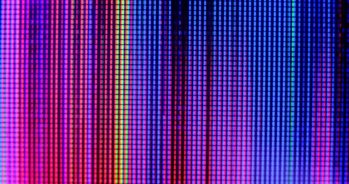 macro view of 4K LED matrix red, blue, and green sub-pixels, monitor, or TV screen. Colored pixels texture creates an abstract pattern.
