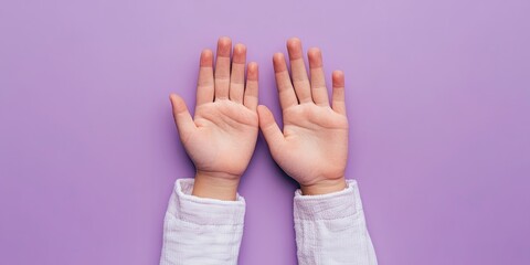 A close up view focuses on a young girls hands against a violet backdrop, capturing the essence of childhood hobbies and youthful interests vividly.