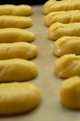 Raw eclairs on a baking sheet.Choux pastry.Dessert.Baking process.Food concept