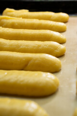 Raw eclairs on a baking sheet.Choux pastry.Dessert.Baking process.Food concept