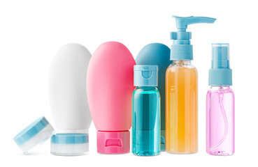 Variety of colorful personal care bottles and grooming accessories arranged on a white surface