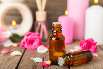 Rose essential oil on a textured background.Roses and a bottle of rose perfumed water.Aromatherapy treatment. Beauty concept. Spa procedure.Natural organic oil.Anti-stress,detox relax.Place for text