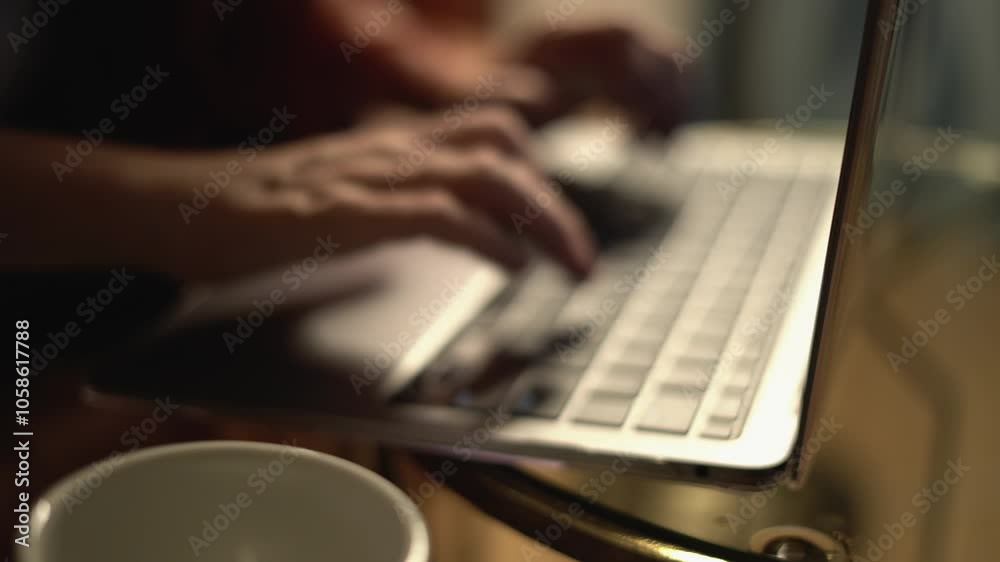 Poster A closeup view showcasing hands actively typing on a contemporary laptop keyboard, set against a softly illuminated environment, highlighting the importance of modern technology in various tasks