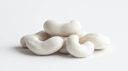 White cashews on a white background, minimalist style, texture details