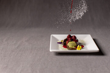 Gourmet Dessert with Cherry Topping and Sugar Dusting