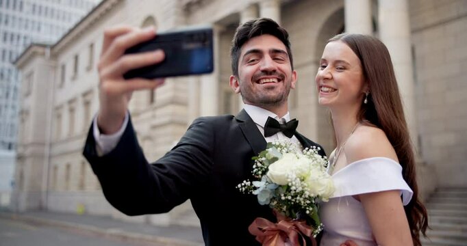 Couple, kiss and selfie for wedding, marriage and love together with fun, joy and commitment in city. Bride, groom and people outdoor for social media, excited or profile picture with romantic memory