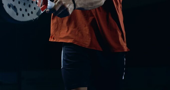 Super slow motion close up of paddle player is hitting ball during competition game match or training workout on indoor court at 1000 fps.