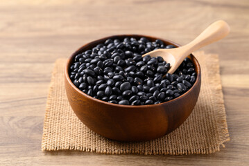 Black bean in wooden bowl with scoop, Food ingredient