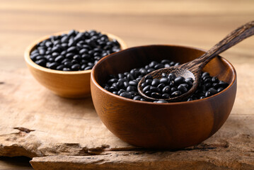 Black bean in bowl with spoon on wooden background, Food ingredient
