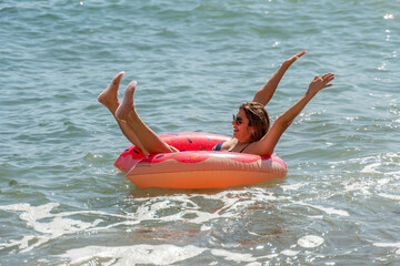 Woman, Float, Ocean: Woman enjoying a relaxing float in the ocean on a sunny day.