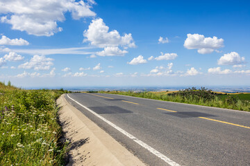 Countryside asphalt road and sky clouds nature background. Road trip.