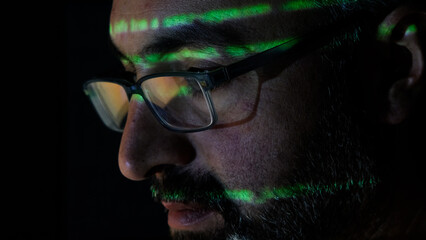 Focused Coder Analyzes Code on Computer Screen in Dark Environment - Cyber security, Cyber Attack, Penetration testing concept.