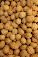 A close-up walnut counter in a farmer`s market, freshly picked ripe genuine walnuts, A pile of walnuts, a close-up walnut counter in a farmer's market.Shallow dof.
