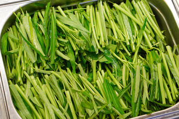 Morning glory cut into pieces and placed in a cooking preparation area.
