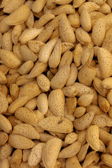 Creative layout made of almond nuts, Flat lay almond, Food concept, Almond pattern concept, natural texture and warm brown hues of the almonds, Healthy organic whole almonds nuts top view.
