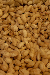 Creative layout made of almond nuts, Flat lay almond, Food concept, Almond pattern concept, natural texture and warm brown hues of the almonds, Healthy organic whole almonds nuts top view.
