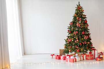 Christmas tree with gifts decorated with toys in the interior for the new year