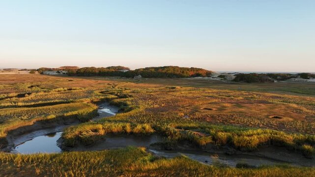 Salt marsh and sand dunes at sunrise at Cape Cod bay, Barnstable, Massachusetts, USA